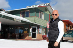 Anthony poses in front of the Western Riviera Hotel in the snowy ski town of Grand Lake, CO.